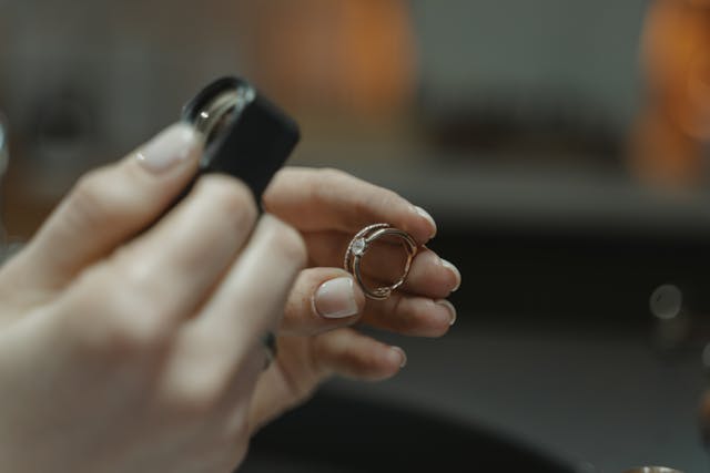 A person examining a ring.