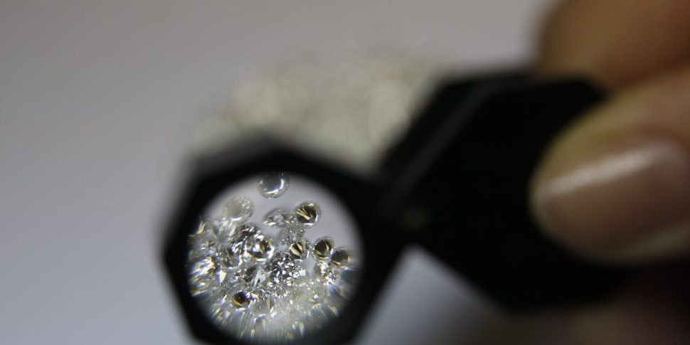 A person examining gems.