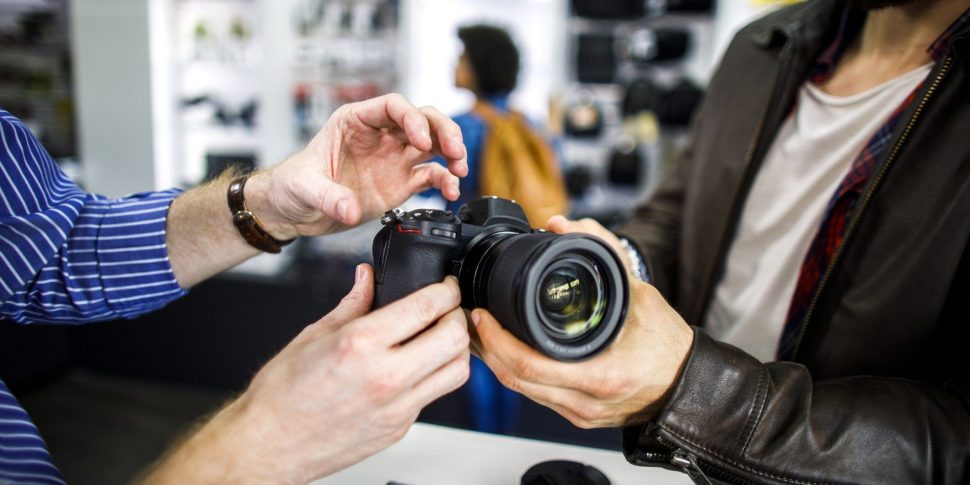 Two people discussing a camera.
